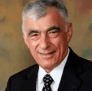 Portrait of an elderly man in a suit and tie.