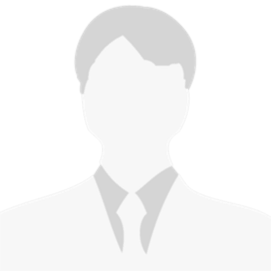 Silhouette of a person in a suit with styled hair.