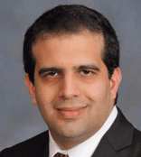 Professional headshot of a man in a suit and tie.